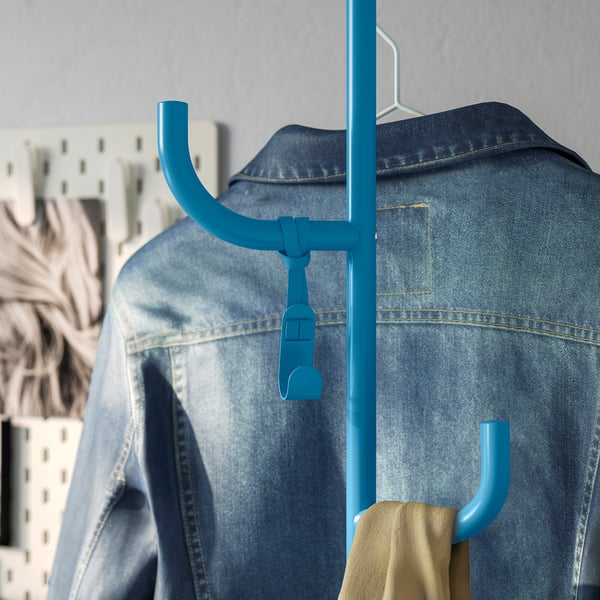 Blue hanging coat rack with jeans and towel, modern design, freestanding.