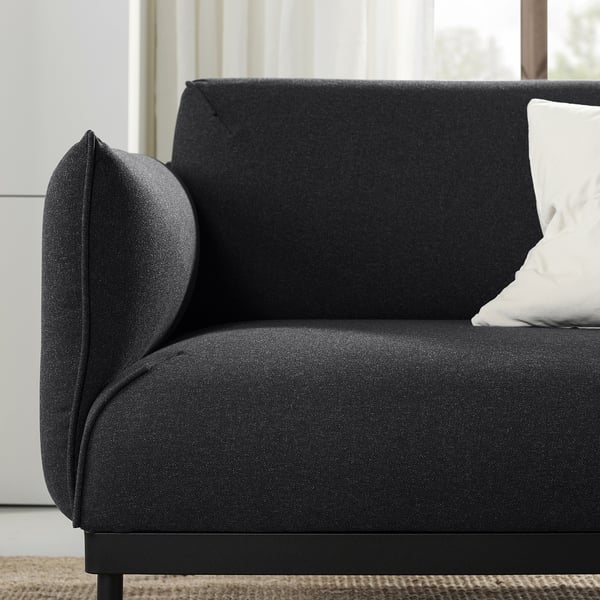 Modern black sofa, dark fabric, minimalist design, comfortable cushions.