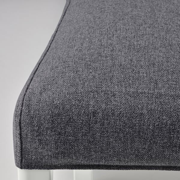 Close-up of cushioned grey fabric on modern chair, showcasing texture and quality material.
