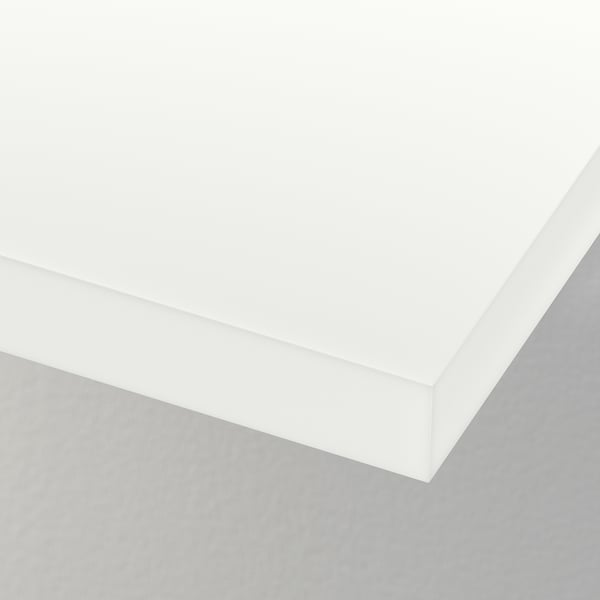 Crisp white corner of a modern wall unit, smooth edges and sleek design.