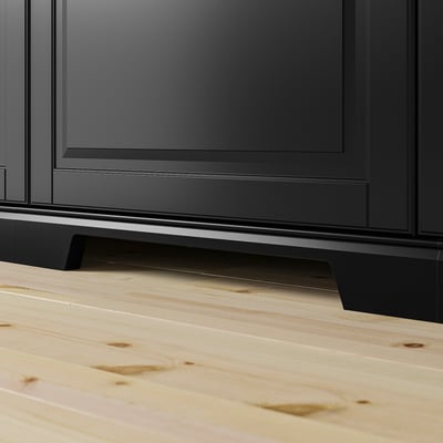 Black kitchen cabinet with wooden floor. Shown with BODBYN plinth.