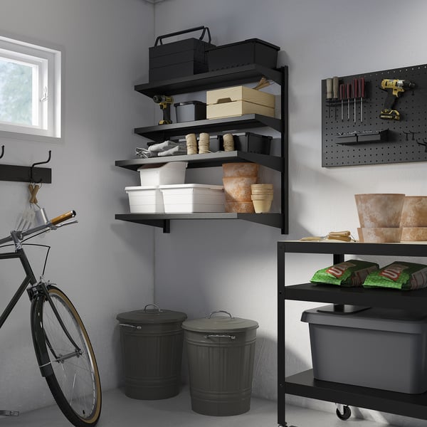 Garage with BROR shelves, tools & supplies. Bike leans, pegboard on right.