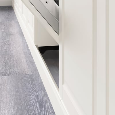 Image shows a kitchen plinth installed under cabinets, covering floor gap, enhancing design.