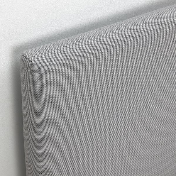 Upholstered bed with soft, textured headboard, showing quality fabric and clean design.