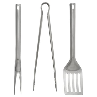 Three stainless steel grilling tools: fork, tongs, spatula with long handles, designed for durability and ease of use.