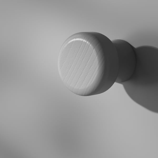 Flat black and white round knobs on grey background. Highlights smooth texture and polished finish.
