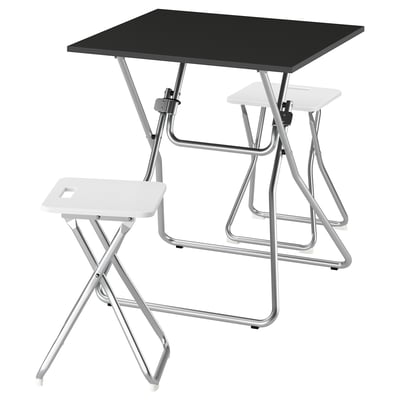 A GUNDE folding table set. It includes a black table and two white stools. The metal frames are silver for durability and easy storage.