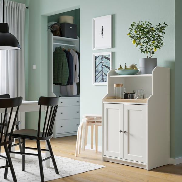 Modern living room with HAUGA storage, chairs, rug, stool, and cabinet decor.