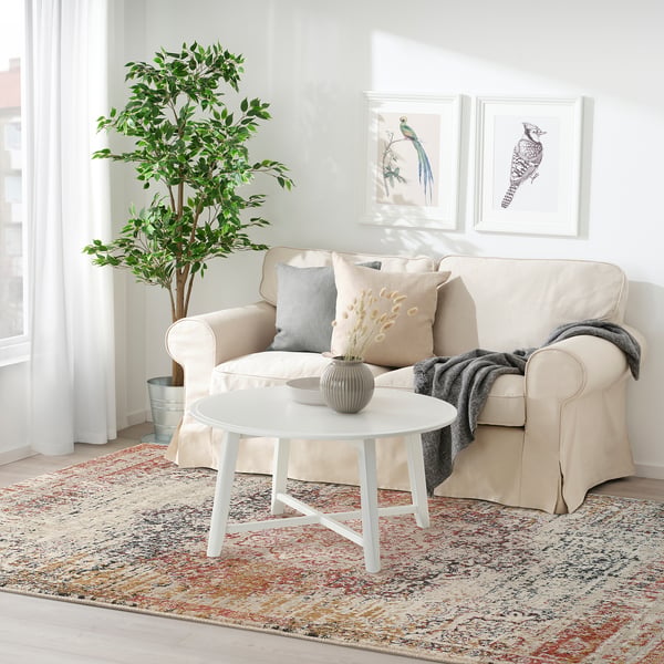 Living room with beige JEJSING rug, sofa, and coffee table.