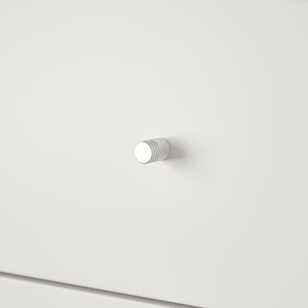 Minimalist modern white hook mounted on pristine white wall.