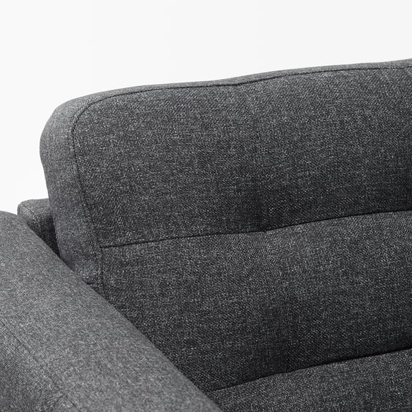 Close-up of modern sofas armrest, showcasing soft, dark grey fabric and plush cushions, highlighting comfort and style.