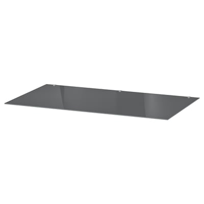A sleek, rectangular grey glass shelf. Its flat with tempered edges, perfect for modern furniture.