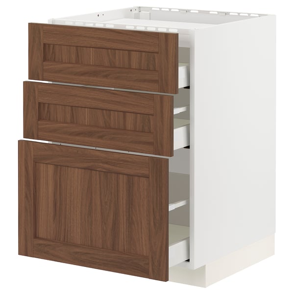 Walnut-colored drawer fronts on white METOD kitchen cabinet with three wooden drawers.
