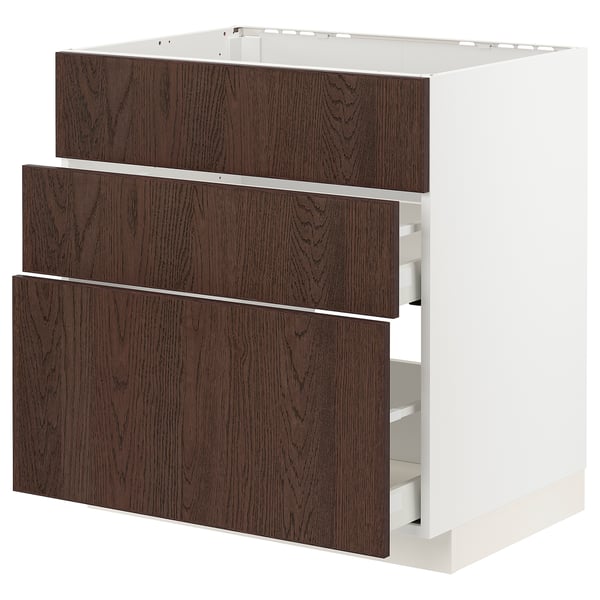 White METOD cabinet with 3 dark brown sinarp wood drawers, rectangular shape.