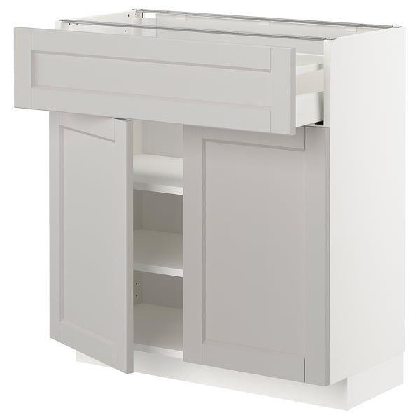 White kitchen cabinet with drawers and adjustable shelves. Modern, clean design.