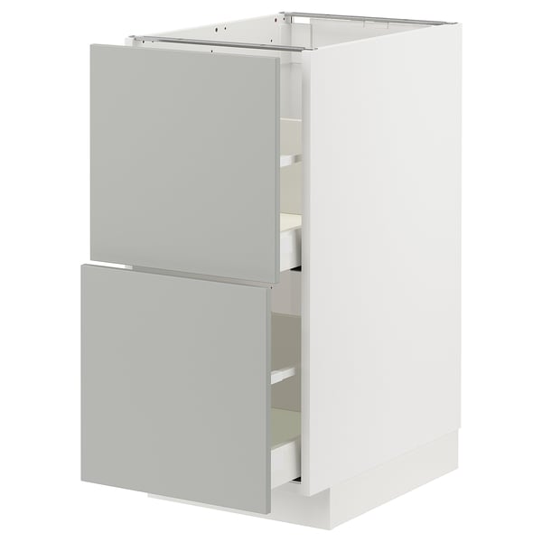 Modern white METOD kitchen cabinet with two light grey drawers & door.