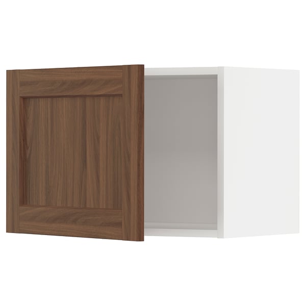 Ikea METOD kitchen cabinet in walnut wood color with white interior.