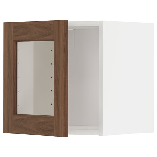 A METOD kitchen cabinet with walnut woodgrain glass doors and white interior, offering a modern and warm design.