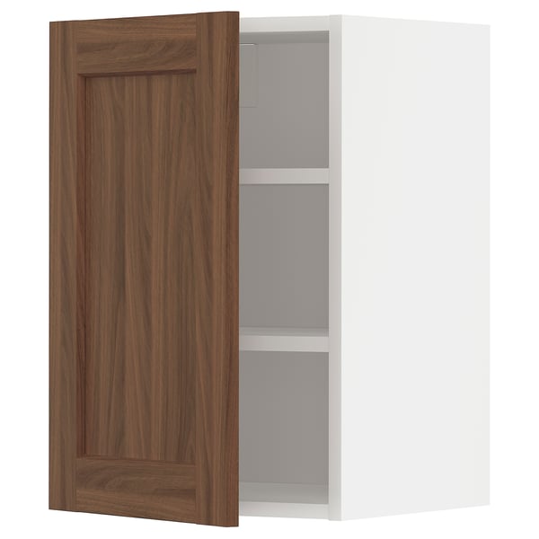 Walnut-colored kitchen cabinet with two shelves, door slightly open.