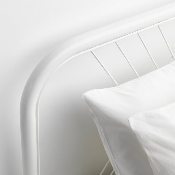 Modern white metal bed with sleek curves and patterned headboard, showcasing durability and clean design.