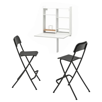 Wall-mounted drop-leaf table with storage and 2 black stools, organised shelves.