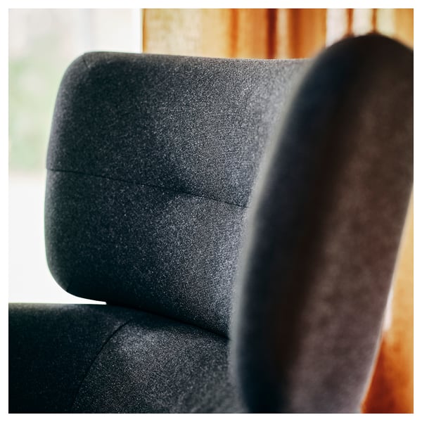 Dark grey upholstered wing chair, showcasing high-quality fabric and comfortable design. The chair appears well-crafted with attention to detail.
