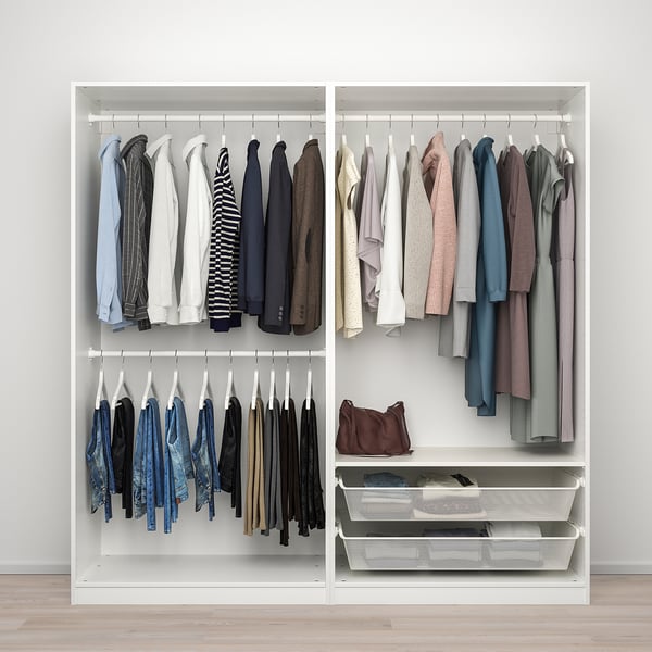 A white PAX wardrobe with sliding doors organised clothes on three rails: jackets, shirts, and trousers. Mesh baskets store folded items beneath.