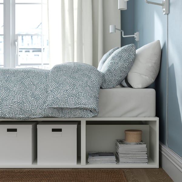 Bed with storage: PLATSA bed saves space, combining sleep & storage. Shelves hold boxes & books, ideal for small rooms.