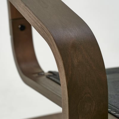 Dark wood chair with sleek, curved backrest; polished finish; smooth texture.