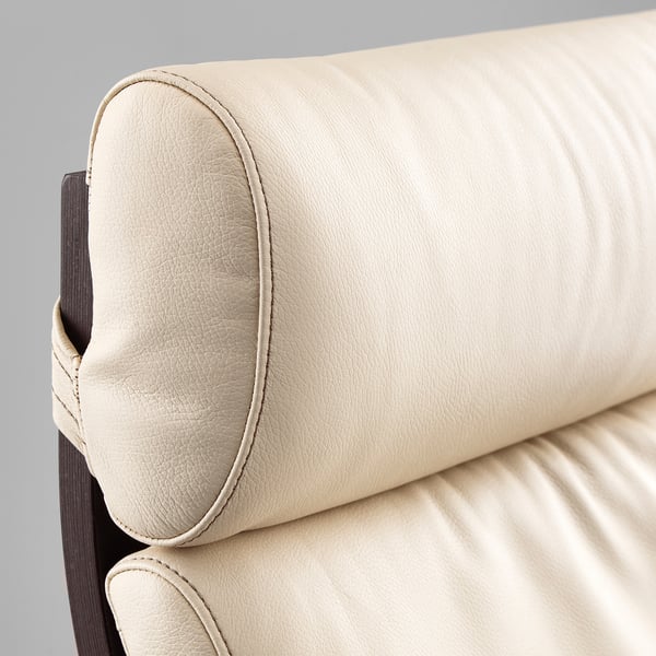 A close-up of a beige leather POÄNG armchair, showcasing its high-quality stitching and smooth finish.