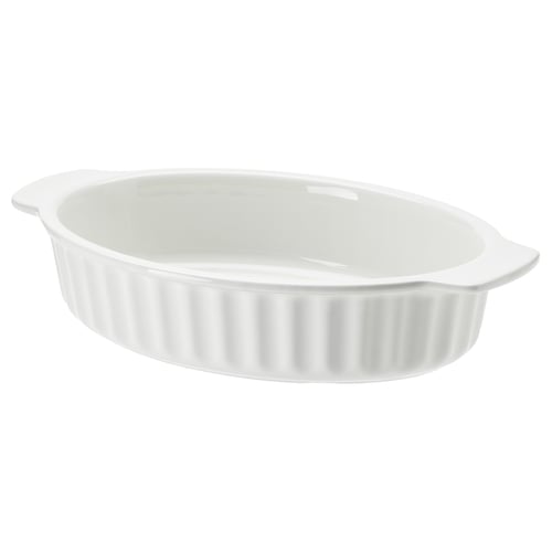 A white oval stoneware baking dish with ribbed design and handles. Ideal for cooking and serving.