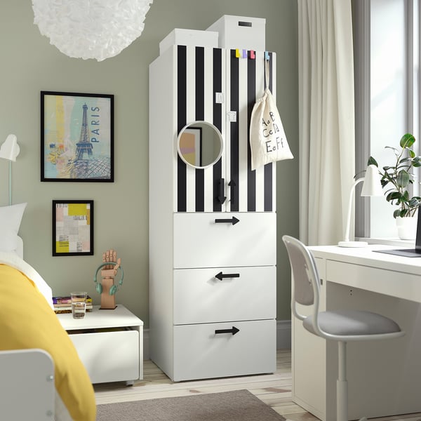 Modern bedroom with SMÅSTAD wardrobe, paris poster, cosy bed, and desk with plant and headphones.