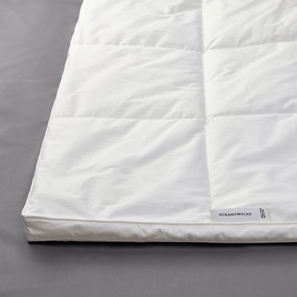Plush white duvet with stitched panels, showcasing soft, inviting texture and quality craftsmanship.