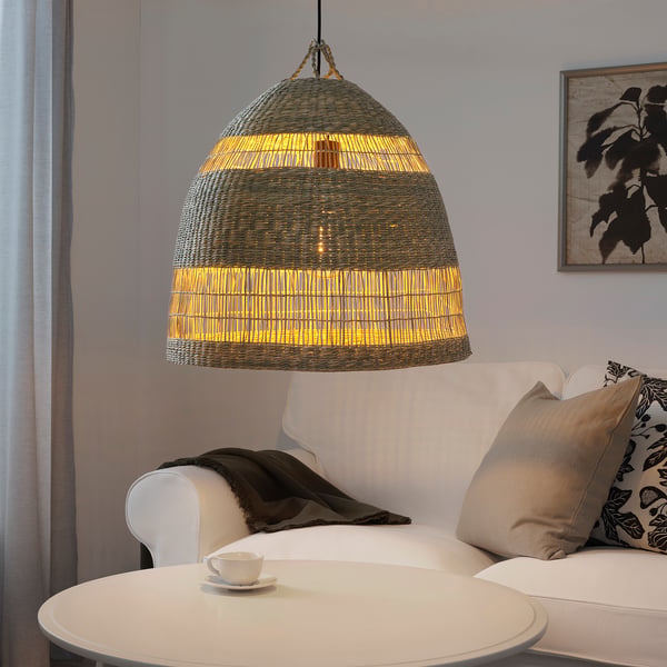 Living room with TORARED lamp over white couch.
