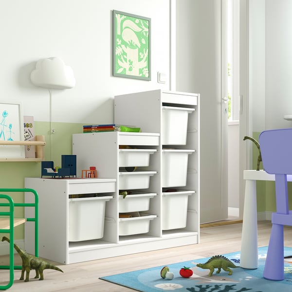 Kids room with TROFAST toy storage. Modular, white units with multiple compartments, ideal for toys. Bright, child-friendly decor with dinosaurs.