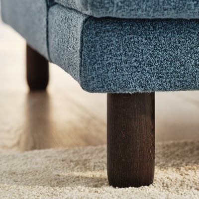 Blue UPPÅKRA sofa close-up, showing dark wood leg, plush upholstery, and cosy texture.