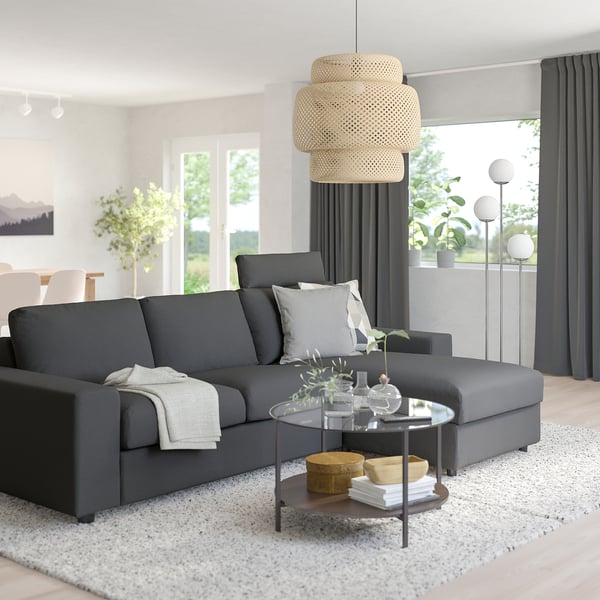 Modern living room: grey VIMLE sofa with sections, coffee table, decorations, plants, large window, curtains, hanging lamp. Cosy and stylish.