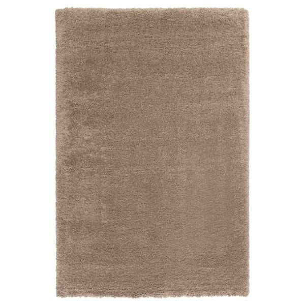 A light brown shaggy rug named VOLLERSLEV. Its soft and textured with long fibres, ideal for comfort.
