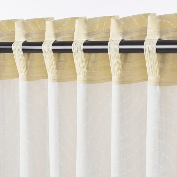 Decomposition of curtain pair hangs, softened light, private view.
