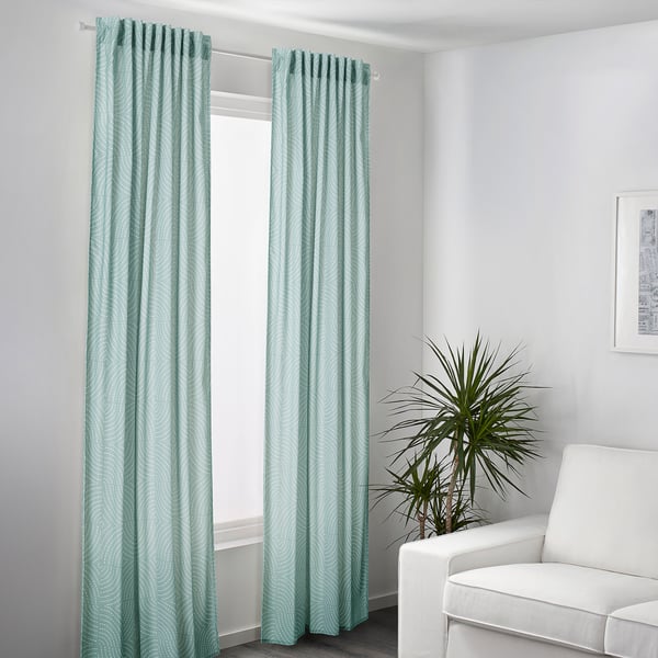 Modern room with ÅKERMOLKE mint curtains, white chair, and tall plant, bright and cosy design.