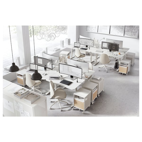 Modern office setup with BEKANT desks, white, ergonomic, adjustable heights, cable management.