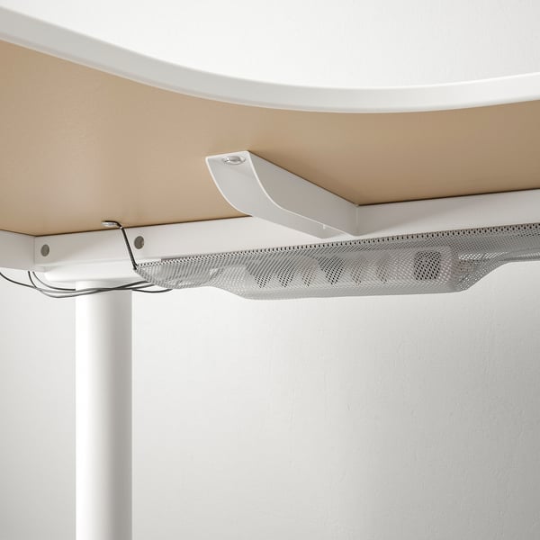 A sturdy BEKANT desk with a large work surface and cable management net, helping keep workspaces organised and neat.