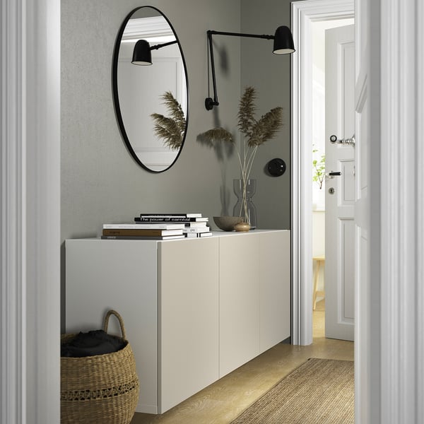 Modern hallway with BESTÅ cabinet, mirror, plants, and lamp.