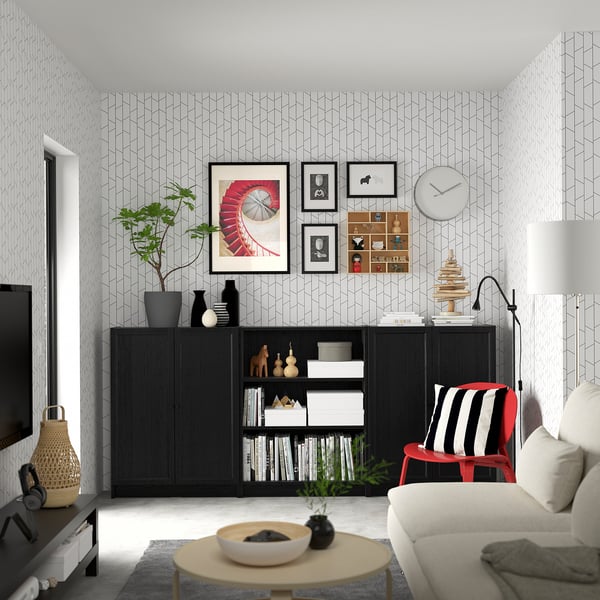 Modern living room with BILLY bookcase, sofa, red chair, tv, decor.