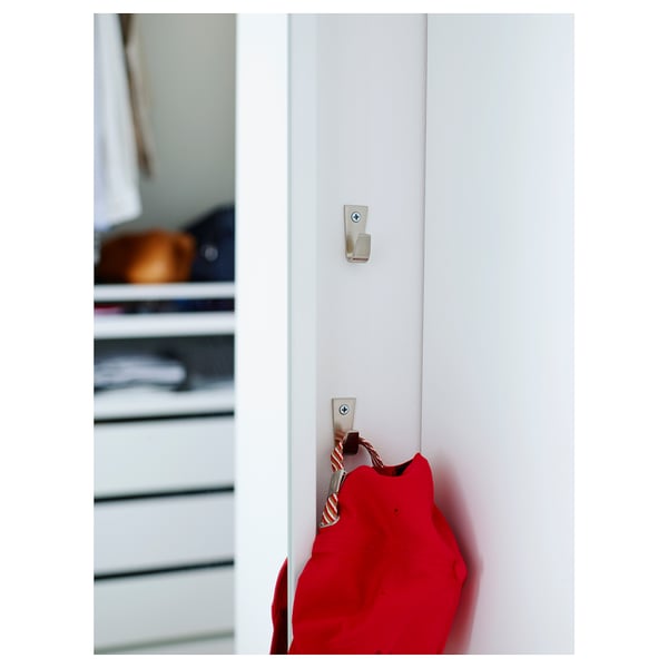 Two zinc hooks with nickel finish, vertically mounted on wall, holding red bag.