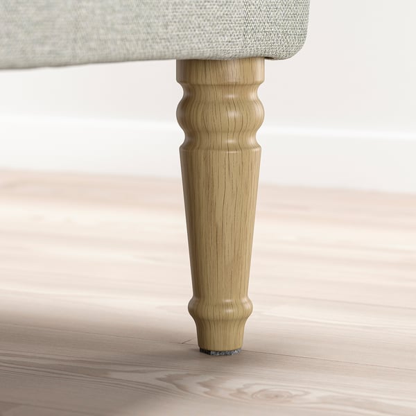 Presswood table leg with turning detail, attached to light-colored table.