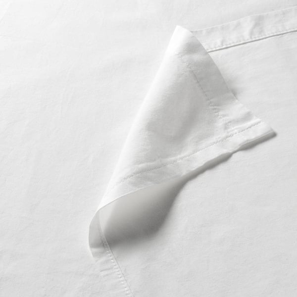 White cotton sheet, neatly folded, showcasing smooth texture and fine stitching.