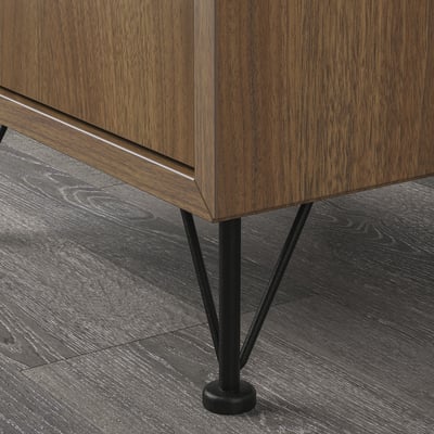 Wooden furniture with sleek, black metal legs and adjustable bases.
