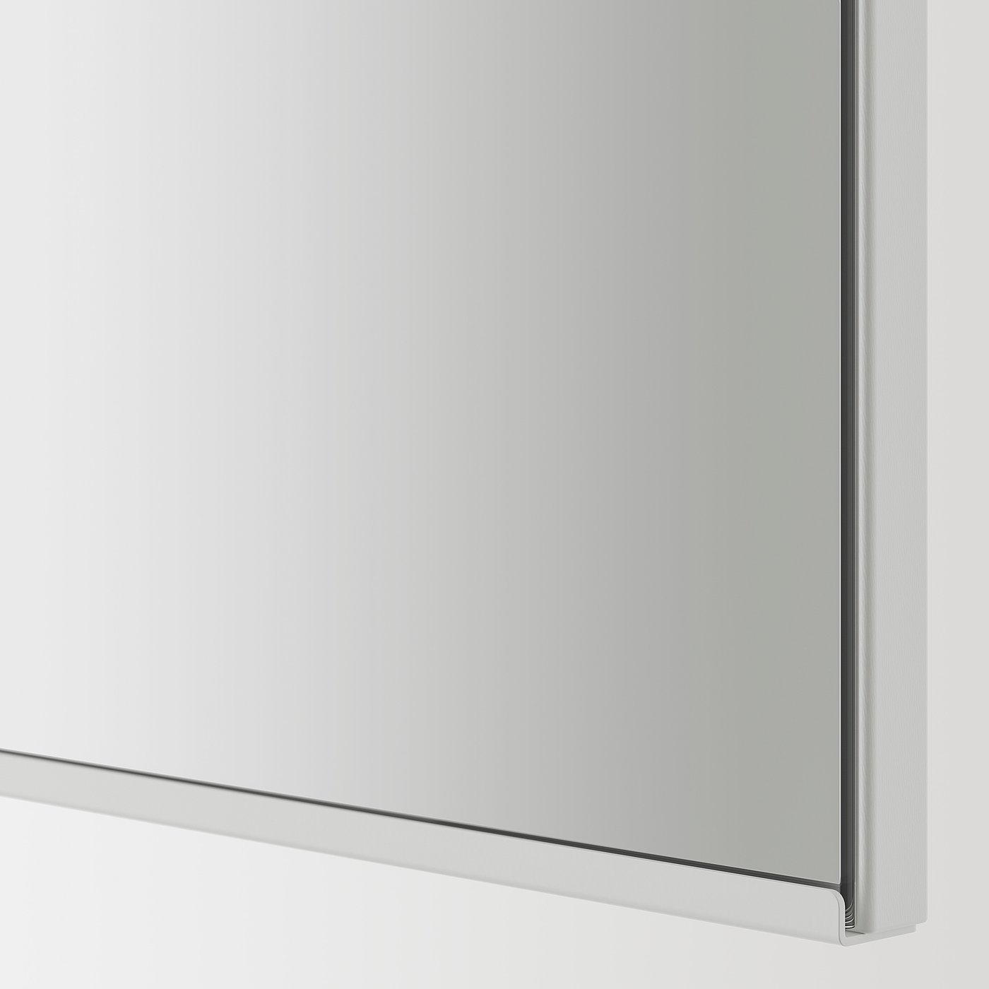 Modern, sleek mirror with polished chrome edge. It reflects light, enhancing room space.
