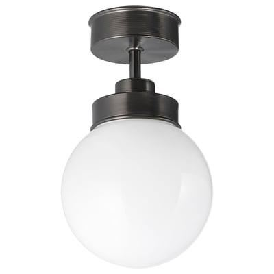 The FRIHULT lamp, matte black, a spherical glass shade and sleek metal base, creating a vintage yet modern design ideal for lighting and ambiance.
